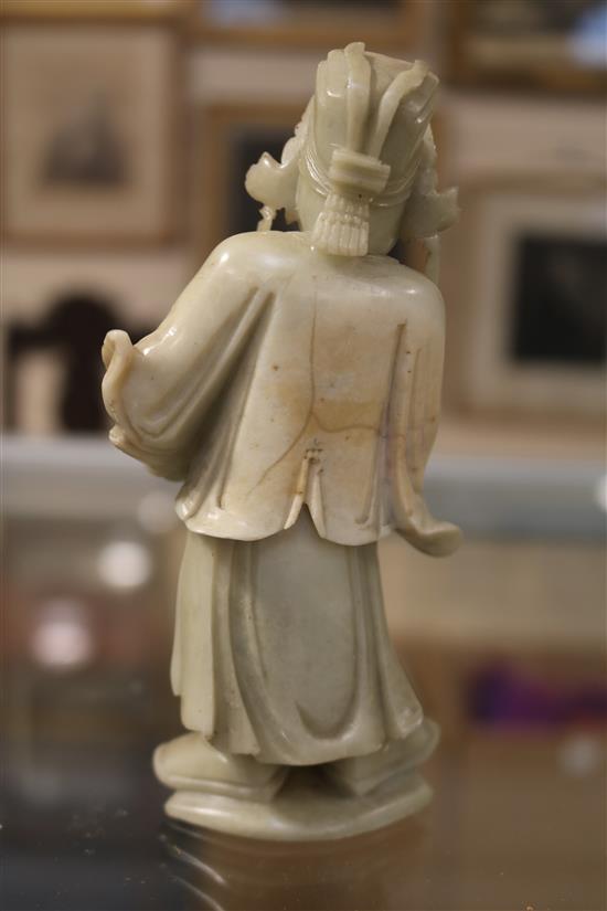 A Chinese soapstone carving of a man holding a jardiniere & other carvings